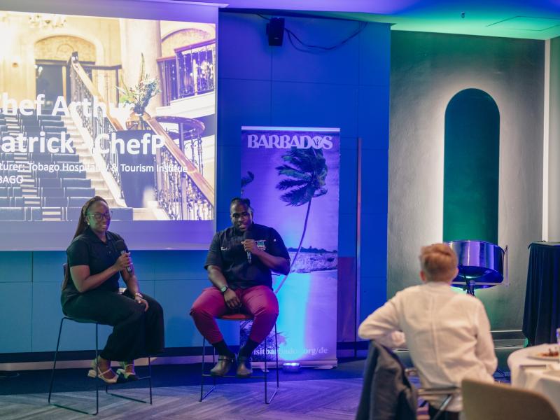 Chef Arthur Patrick and Marketing Officer Perl Henry presenting to German travel agents