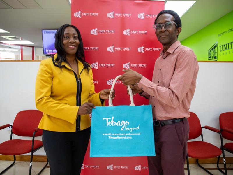 TTAL Director of Product Development and Destination Management, Mr. Wendell Walker, presents UTC Financial Advisor Mrs. Desiree Hackett-Murray, with a token of appreciation for her insightful and engaging presentation